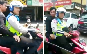 Viral Polisi Bonceng Penumpang Tanpa Helm Sambil Main Ponsel, Warganet Geram