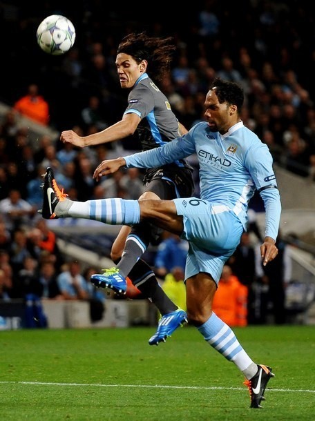Gambar Foto Edinson Cavani dari Napoli bersaing mendapatkan bola dengan Joleon Lescott dari Manchester City
