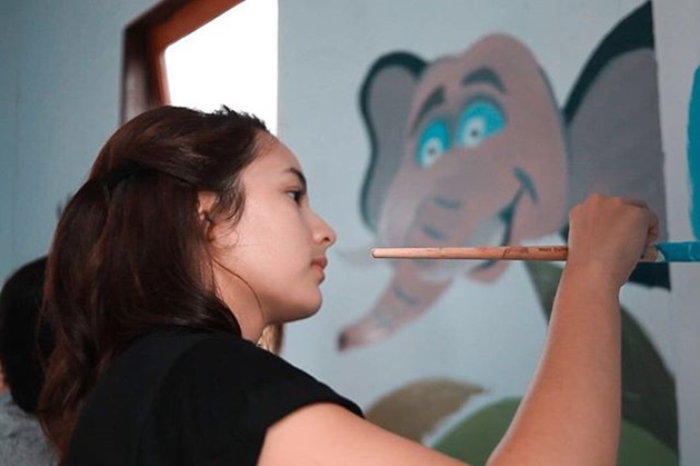 Gambar Foto Setelah peresmian, Chelsea Islan juga ikut menggambar hiasan di sekolah Honai Belajar Anak.