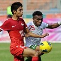 Titus Bonai Saling Berebut Bola dengan Pemain Singapura