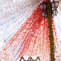 Rangkaian Bunga Kertas Dijadikan Tirai yang Digantung di Lampu Jalan