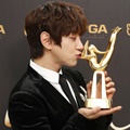 Hwang Chi Yeul mencium trofi Disc Bonsang miliknya di Golden Disc Awards 2018.