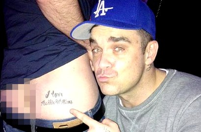 Robbie Williams Pose di Sebelah Pantat Fans